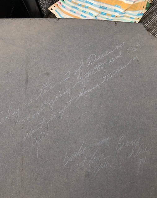 Assembly plant worker message found on the rear seat trunk separator panel. 

